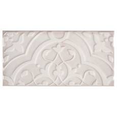 a white tile with an intricate design on it