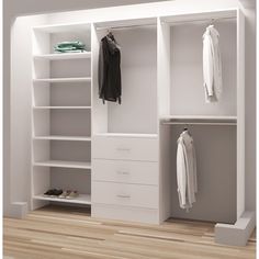 an empty white closet with clothes and shoes