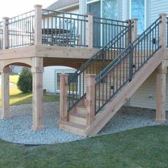 a wooden deck with metal railing and stairs