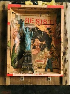 a wooden box with an image of the statue of liberty and other things in it