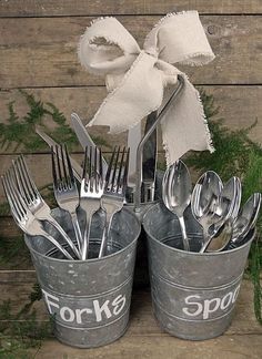 forks, spoons and knives are sitting in buckets