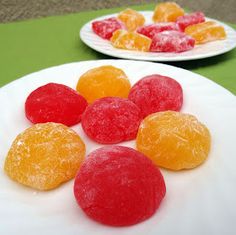 two plates with oranges and raspberries on them