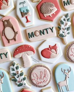 decorated cookies are arranged on top of each other in the shape of animals and trees