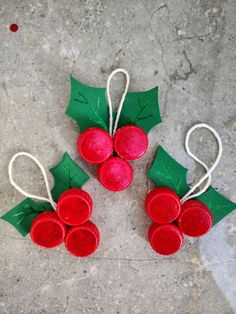 three red and green christmas decorations on the ground