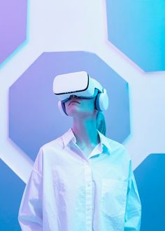 a man wearing a white shirt and blue pants is using a virtual reality headset