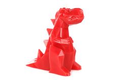 a red candle shaped like a dinosaur