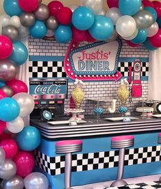 an ice cream parlor decorated with balloons and checkered table cloths for a birthday party