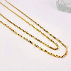 For those who love a touch of sophistication mixed with a bit of edge, our box chain is the perfect style statement. Whether you're layering or wearing it solo, these pieces add a glamorous touch to any outfit. Versatile and timeless, they exude elegance with an edge. (Just like you!) Yellow Gold Box Chain Necklace For Layering, Double Strand Box Chain Necklace For Gift, Double Strand Box Chain Necklace For Gift Giving, Layering Link Necklace With Box Chain, Gift Double Strand Box Chain Necklace, Gold Double Strand Box Chain Necklace, Long Box Chain Necklace As Gift, Snake Chain Link Necklace With Box Chain For Gift, Gift Box Chain Long Necklace