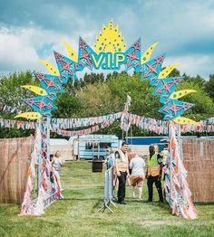 some people are standing in the grass near a sign that says vaup on it