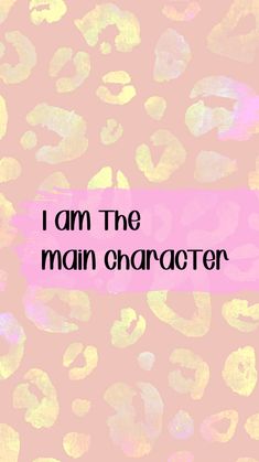 the words i am the main character are painted in gold and pink on a pink background