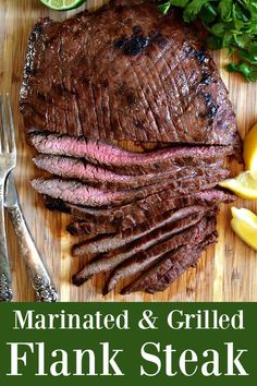 the steak is sliced up and ready to be served with lemons, parsley and herbs