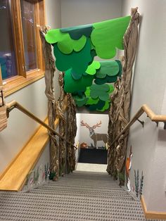 the hallway is decorated with paper trees and deer