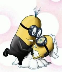 a couple of minions hugging each other on top of a bed with eyeglasses