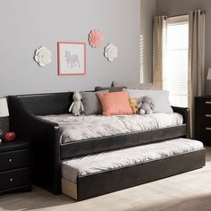 a bedroom with a daybed, dresser and two night stands