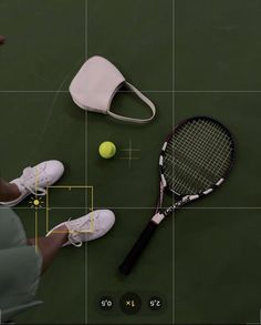 a tennis racket and ball on the ground with a white bag next to it