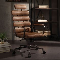 a brown office chair sitting in front of a bookshelf filled with stacks of books