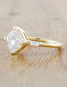 a diamond ring sitting on top of a wooden table