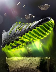 an image of a soccer shoe that is glowing in the dark with rocks and debris surrounding it