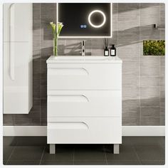 a white bathroom vanity with a mirror above it