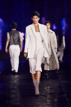 models walk down the runway in white outfits