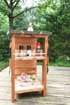 an outdoor grill made out of wood with spices and condiments on the top