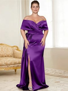 a woman in a purple dress posing for the camera