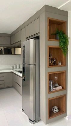 a modern kitchen with stainless steel appliances and white tile flooring is pictured in this image