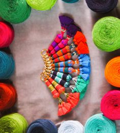 several skeins of colorful yarn are arranged in a circle on top of each other