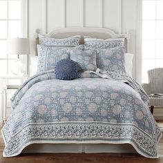 a blue and white comforter set with pillows