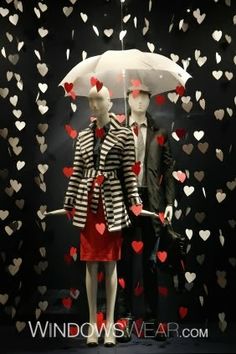 two mannequins dressed in black and white with red hearts