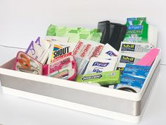 a white container filled with lots of different types of toiletries and toothpaste