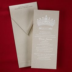 a wedding card with a tiara on the front and back, sitting next to an envelope