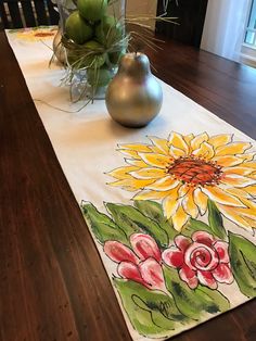 a table runner with flowers painted on it