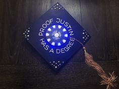 a blue graduation cap with the words proof justin's a degree on it