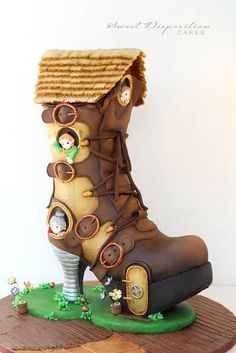 there is a cake made to look like a boot with people inside and on it