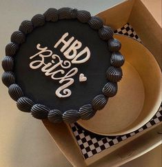 a black and white cake with the words happy birthday on it