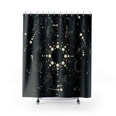 a black shower curtain with gold stars and planets in the sky, on a white background