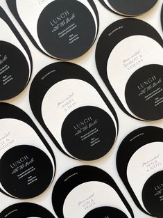 black and white business cards are arranged in rows on top of each other, with the words lunch written below them