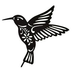 a black and white hummingbird flying with its wings spread out to the right side