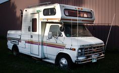 an rv parked in front of a building