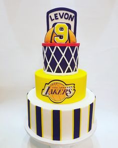 a three tiered cake with the number 9 on it's side and basketball hoop