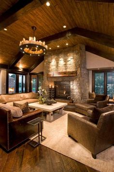 a living room filled with furniture and a fire place in the middle of a room