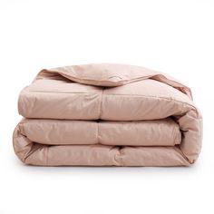 three pillows stacked on top of each other in front of a white background with the sheets folded down