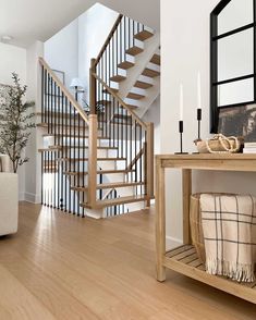 a living room filled with furniture and a stair case