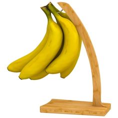 three bananas are hanging from a wooden stand