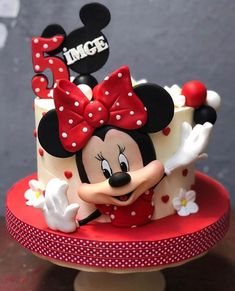 a minnie mouse cake with red and white polka dots