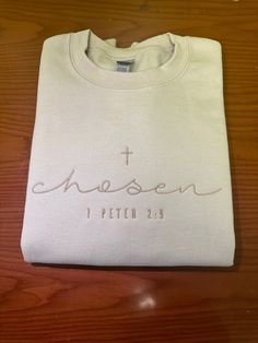 Embroidered Chosen Sweatshirt, Bible Verse Peter Shirt, Christian Crewneck, Embroidered Christian Hoodie, Gifts For Christians E016 COLOR AND SYTLE :  Sweatshirt Color: Sand Thread Color : Tusk  Our custom shirts are the perfect gift for your loved ones, guaranteeing their admiration for years to come. At Custom PANDA shirts, we pride ourselves on providing unparalleled customer service, post-sale support, and top-quality products. Our dedicated team meticulously crafts each shirt to order, ensuring your satisfaction from the moment you place your order to its delivery. Our shirts feature premium materials, setting industry standards. We collaborate with leading apparel companies to ensure you receive the finest products on the market. We promise you won't regret choosing us. Thank you for Embroidered Bible Verse Shirt, Mens Embroidered Sweatshirt, Christian Crewneck Sweatshirt, Christian Embroidered Sweatshirt, Cute Embroidered Sweatshirt, Chosen Sweatshirt, Gifts For Christians, Christian Sweaters