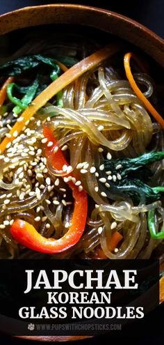 a bowl filled with noodles and vegetables on top of a table