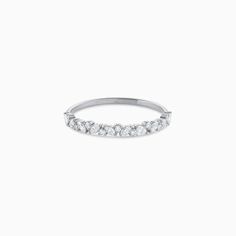 a white gold ring with five diamonds on the top and bottom, set in 18k white gold