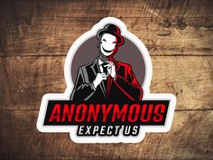 an anonymous expect us sticker on a wooden background